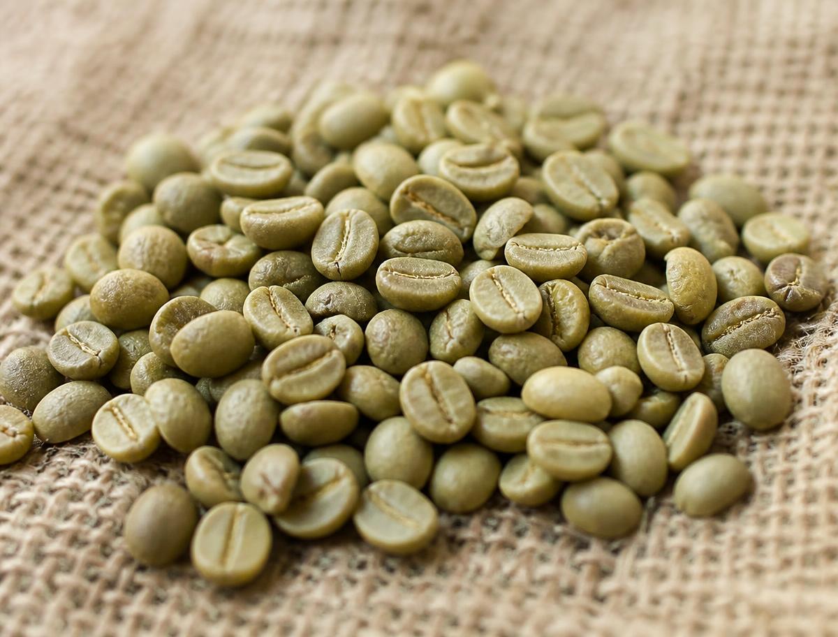 Raw green coffee beans resting on burlap